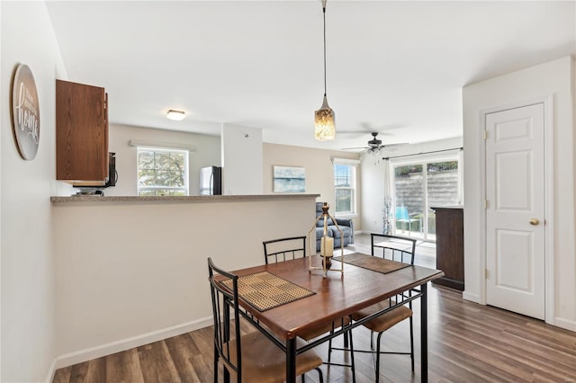 dining area featuring dark hardwood / wood-style floors and ceiling fan