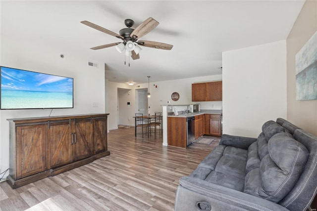 living room featuring light hardwood / wood-style floors and ceiling fan