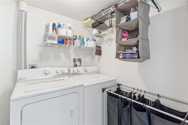 clothes washing area with washing machine and dryer