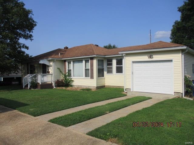 ranch-style home with a garage and a front yard