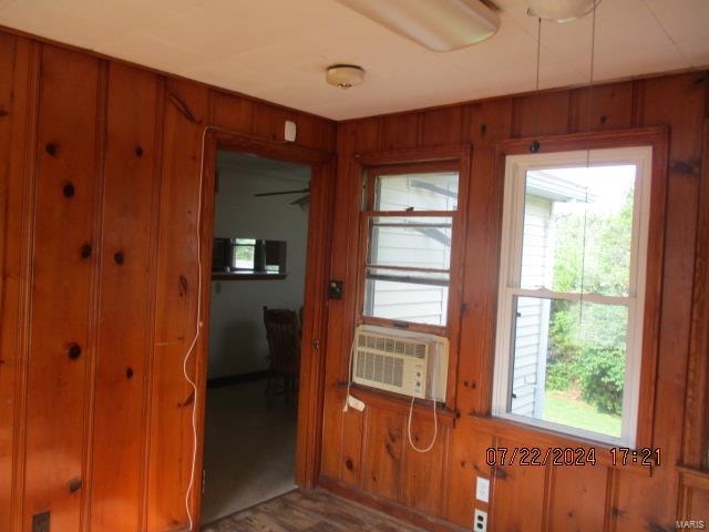 entryway featuring cooling unit and wood walls