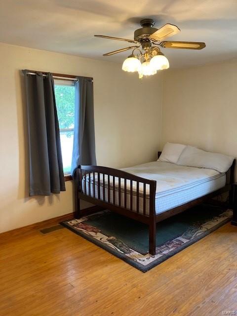 bedroom featuring hardwood / wood-style flooring and ceiling fan