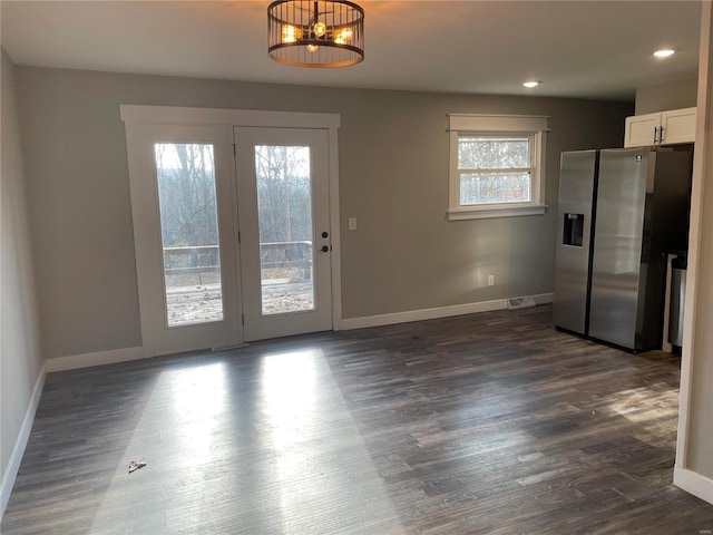 interior space with dark hardwood / wood-style floors and an inviting chandelier