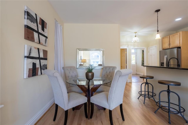 dining space with light hardwood / wood-style flooring