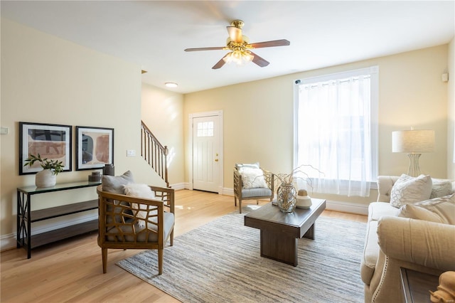 living room with ceiling fan and light wood-type flooring