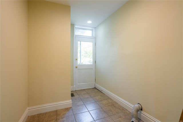 doorway to outside with light tile patterned floors