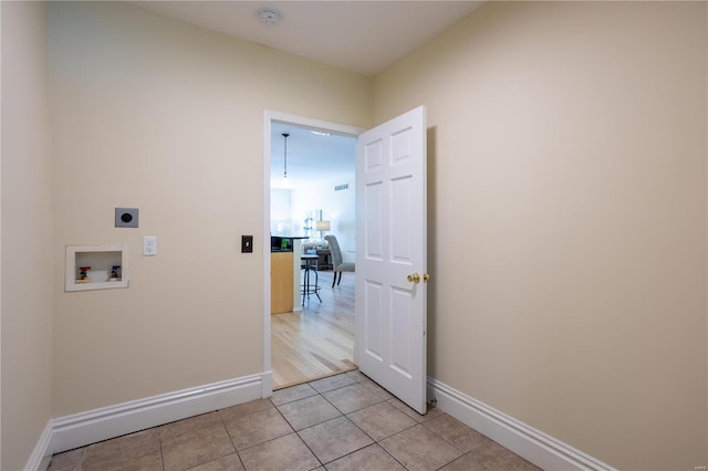 laundry room with electric dryer hookup, light tile patterned floors, and hookup for a washing machine