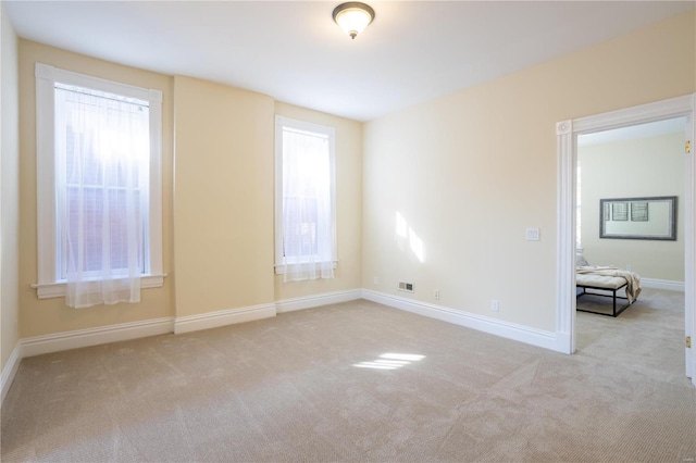 carpeted empty room with a wealth of natural light