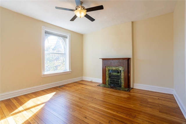 unfurnished living room with ceiling fan and light hardwood / wood-style floors