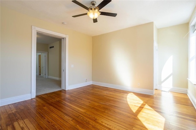 spare room featuring light hardwood / wood-style flooring and ceiling fan