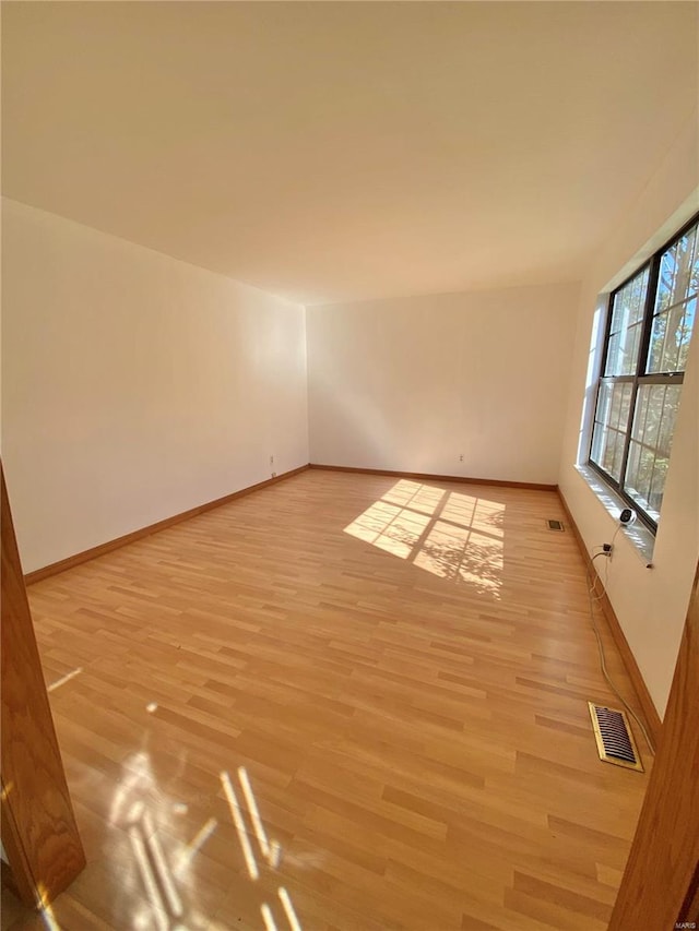 unfurnished room with light hardwood / wood-style flooring