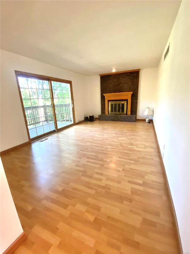 unfurnished living room featuring a fireplace and light wood-type flooring