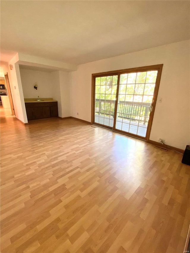 unfurnished living room with light wood-type flooring