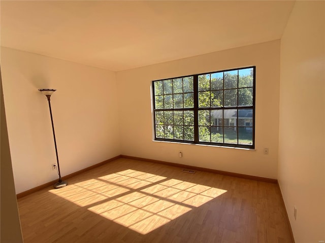 unfurnished room with wood-type flooring