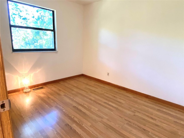 unfurnished room featuring hardwood / wood-style flooring