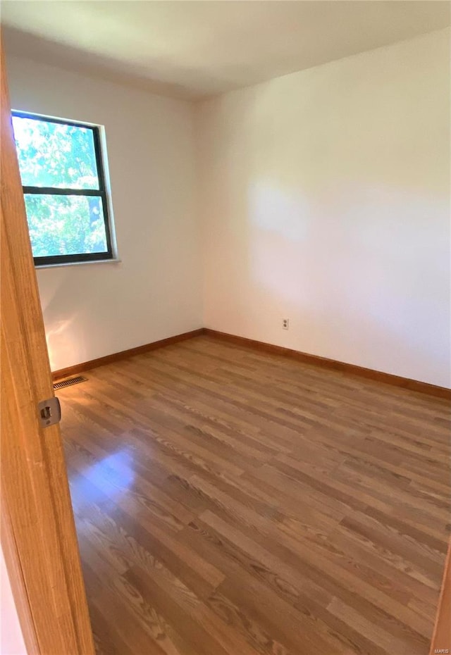 spare room featuring dark hardwood / wood-style floors