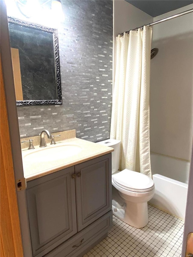 full bathroom with vanity, shower / tub combo with curtain, toilet, and tile patterned floors