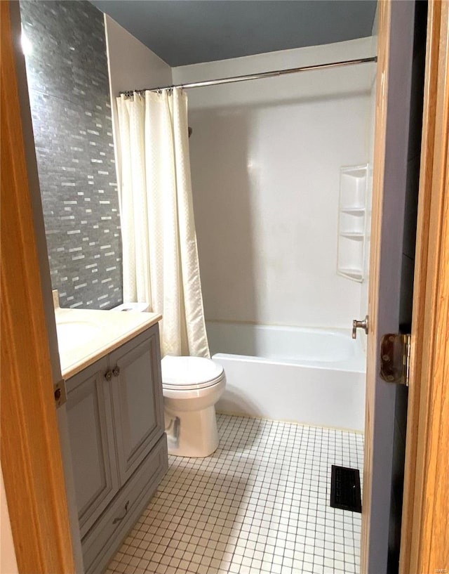 full bathroom with vanity, toilet, shower / bathtub combination with curtain, and tile patterned flooring