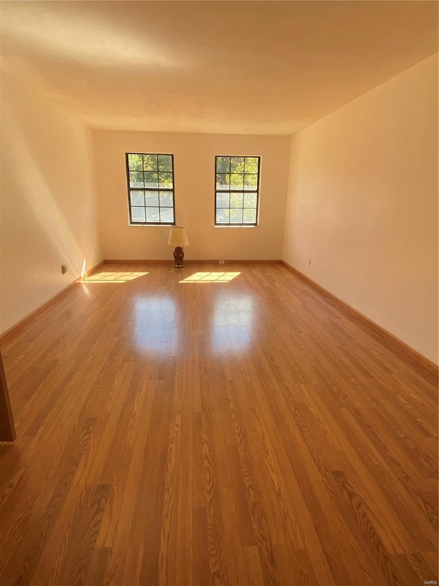 empty room with hardwood / wood-style flooring