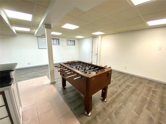 game room with a paneled ceiling and hardwood / wood-style floors