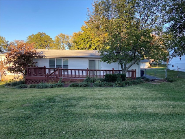 view of front of home with a front yard and a deck