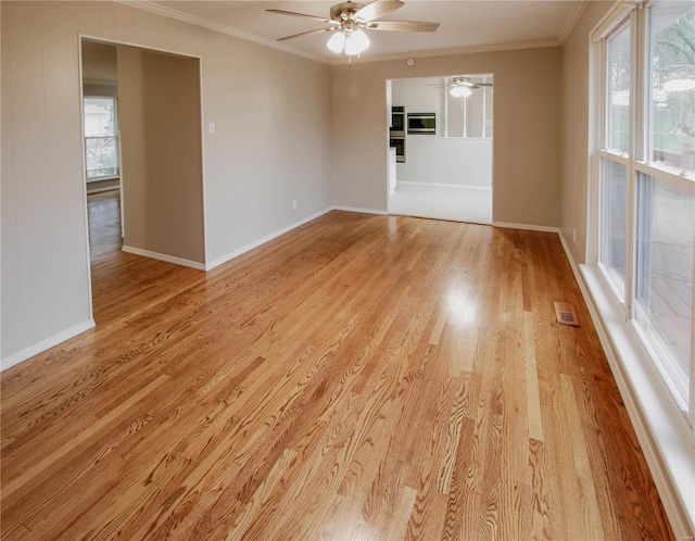 unfurnished room with light wood-type flooring, ceiling fan, and ornamental molding