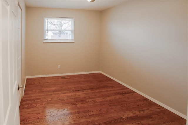 spare room featuring dark hardwood / wood-style floors