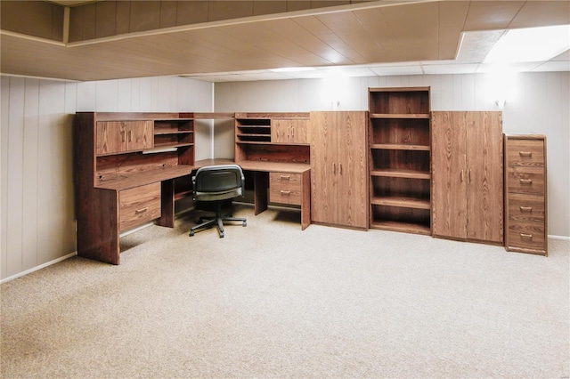 carpeted office featuring wooden walls