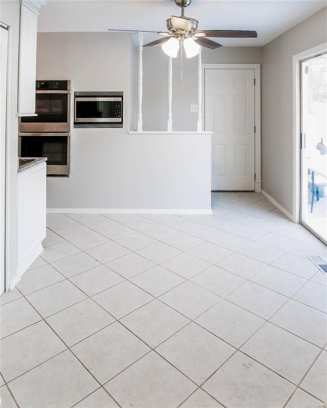 interior space with ceiling fan