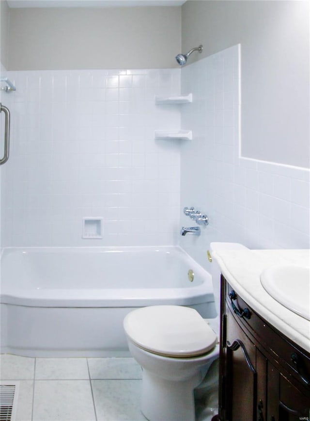 full bathroom featuring vanity, tile patterned floors, shower / washtub combination, toilet, and tile walls