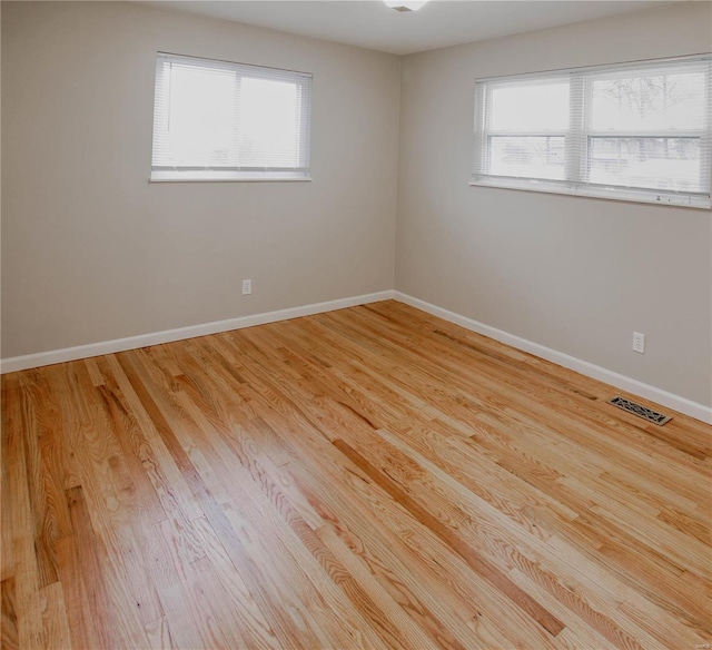 spare room with light hardwood / wood-style floors