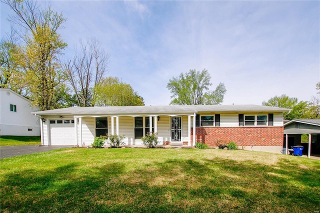 single story home featuring brick siding, an attached garage, aphalt driveway, and a front lawn