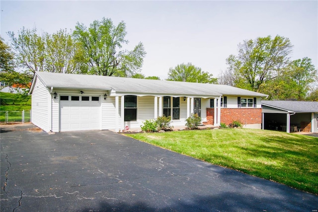ranch-style house featuring an attached garage, a porch, a front yard, and driveway