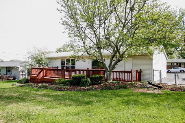 back of house with a yard, fence, and a deck