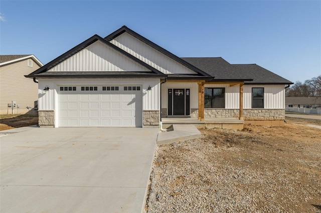 modern farmhouse style home with a garage, stone siding, a shingled roof, and concrete driveway