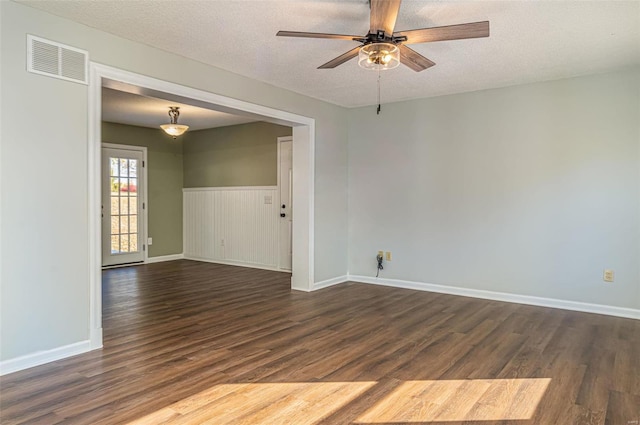 unfurnished room featuring ceiling fan, a textured ceiling, and dark hardwood / wood-style floors