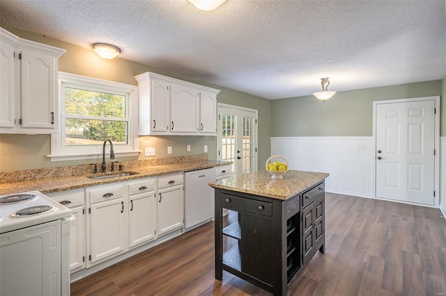 kitchen with sink, white cabinetry, dishwasher, and dark hardwood / wood-style floors