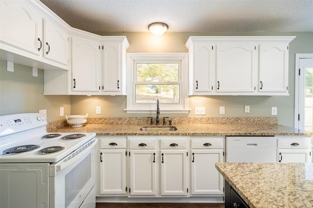 kitchen featuring white cabinetry, white electric range, sink, and a textured ceiling