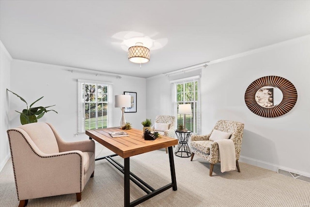 home office featuring light carpet, crown molding, and plenty of natural light