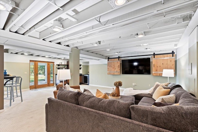 living room featuring french doors, a barn door, and light colored carpet