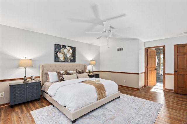 bedroom featuring ensuite bathroom, hardwood / wood-style flooring, and ceiling fan