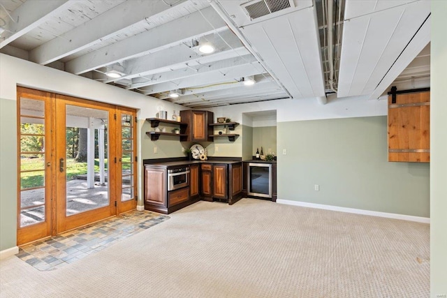 bar with light carpet, oven, and a barn door