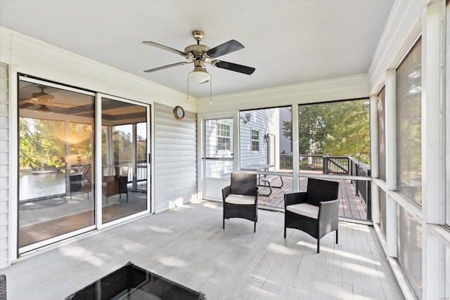 sunroom featuring ceiling fan