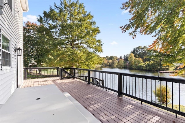 wooden terrace featuring a water view