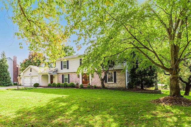 view of front of property with a front yard and a garage