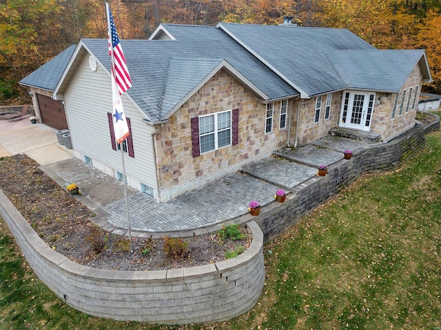 rear view of property featuring french doors and central AC unit