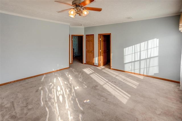 unfurnished room featuring ceiling fan, light carpet, a textured ceiling, and crown molding