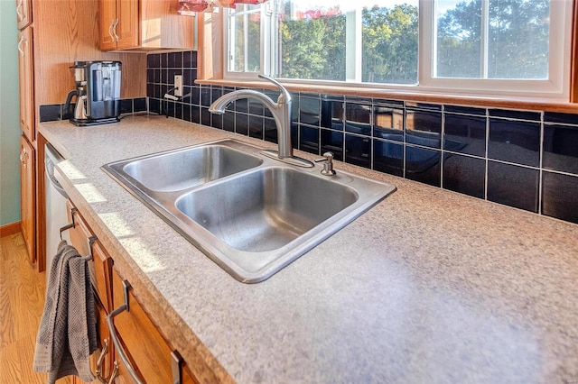 kitchen featuring sink, wood-type flooring, and tasteful backsplash