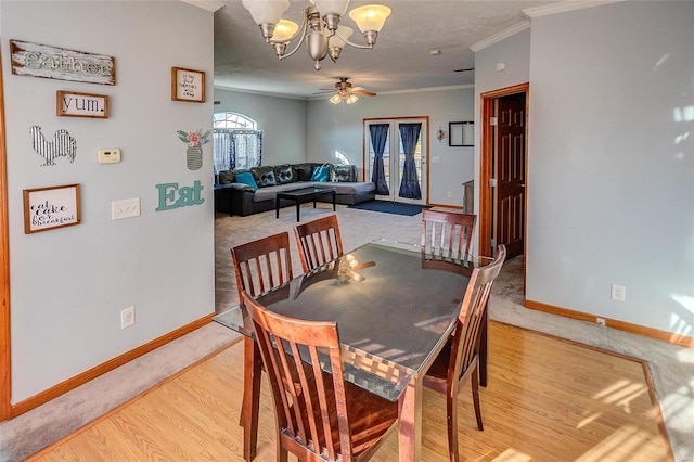 dining space featuring ornamental molding, hardwood / wood-style flooring, and ceiling fan with notable chandelier