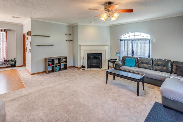 carpeted living room featuring crown molding, a textured ceiling, and ceiling fan